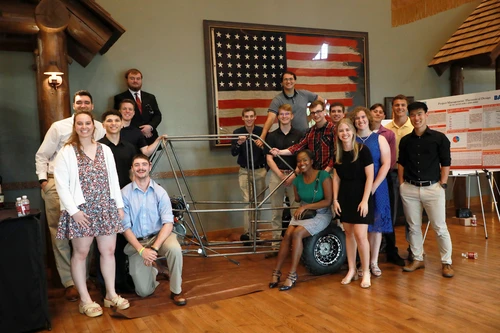 Senior engineering cohort with their dune buggy 